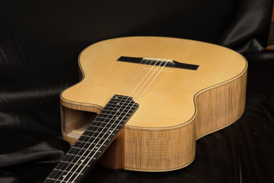 High angle view of guitar on bed