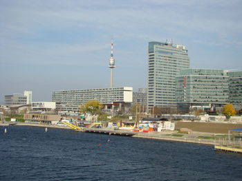 View of buildings at waterfront against sky