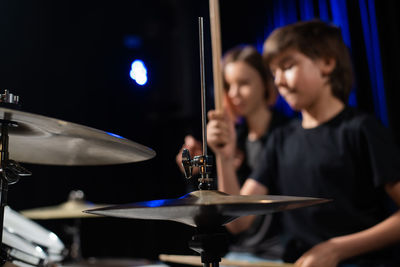 Midsection of man playing drum