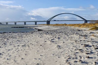 Bridge over beach against sky