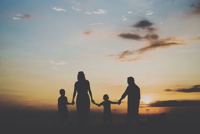 Silhouette of people at sunset