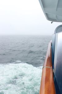 Close-up of boat in sea against clear sky
