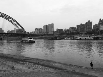 View of bridge over river in city against clear sky