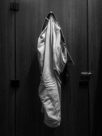 Close-up of jeans hanging on door at home