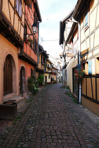 Empty alley amidst buildings in town