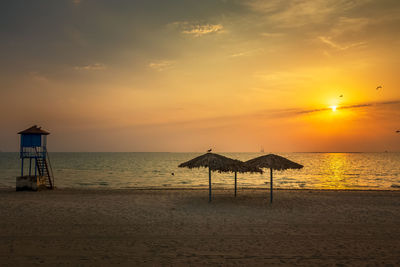 Scenic view of beach against sky during sunset