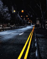 View of yellow lights on road at night