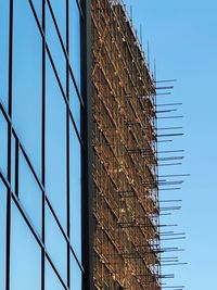 Low angle view of modern building against clear blue sky