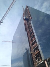 Low angle view of buildings against cloudy sky