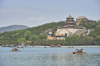 People in sea against sky