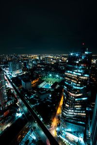 High angle view of illuminated buildings in city at night