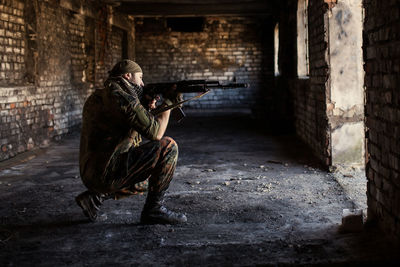 Arab soldier aiming with kalashnikov ak-47 assault rifle.