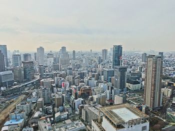 High angle view of modern buildings in city against sky