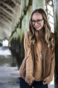 Portrait of smiling young woman standing outdoors