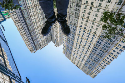 Low section of man standing by building