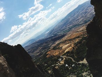 Scenic view of mountains against cloudy sky