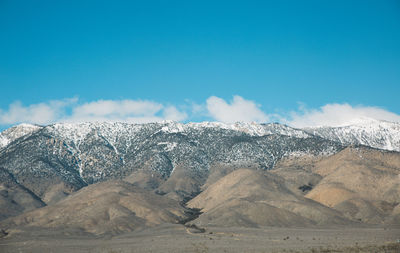 Scenic view of mountain against blue sky