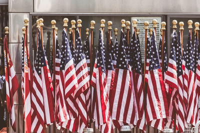 Close-up of flags against glass wall