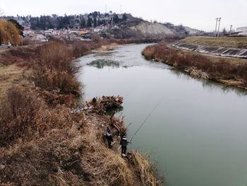 Scenic view of river amidst trees against sky