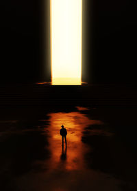 Silhouette man walking in dark room