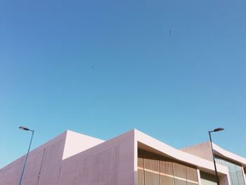 High section of building against clear blue sky