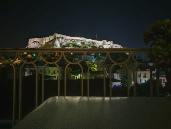 Illuminated building against sky at night