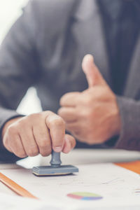 Midsection of man working on table