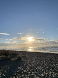 Scenic view of beach against sky during sunset