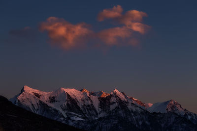 Scenic view of snowcapped mountains against sky during sunset