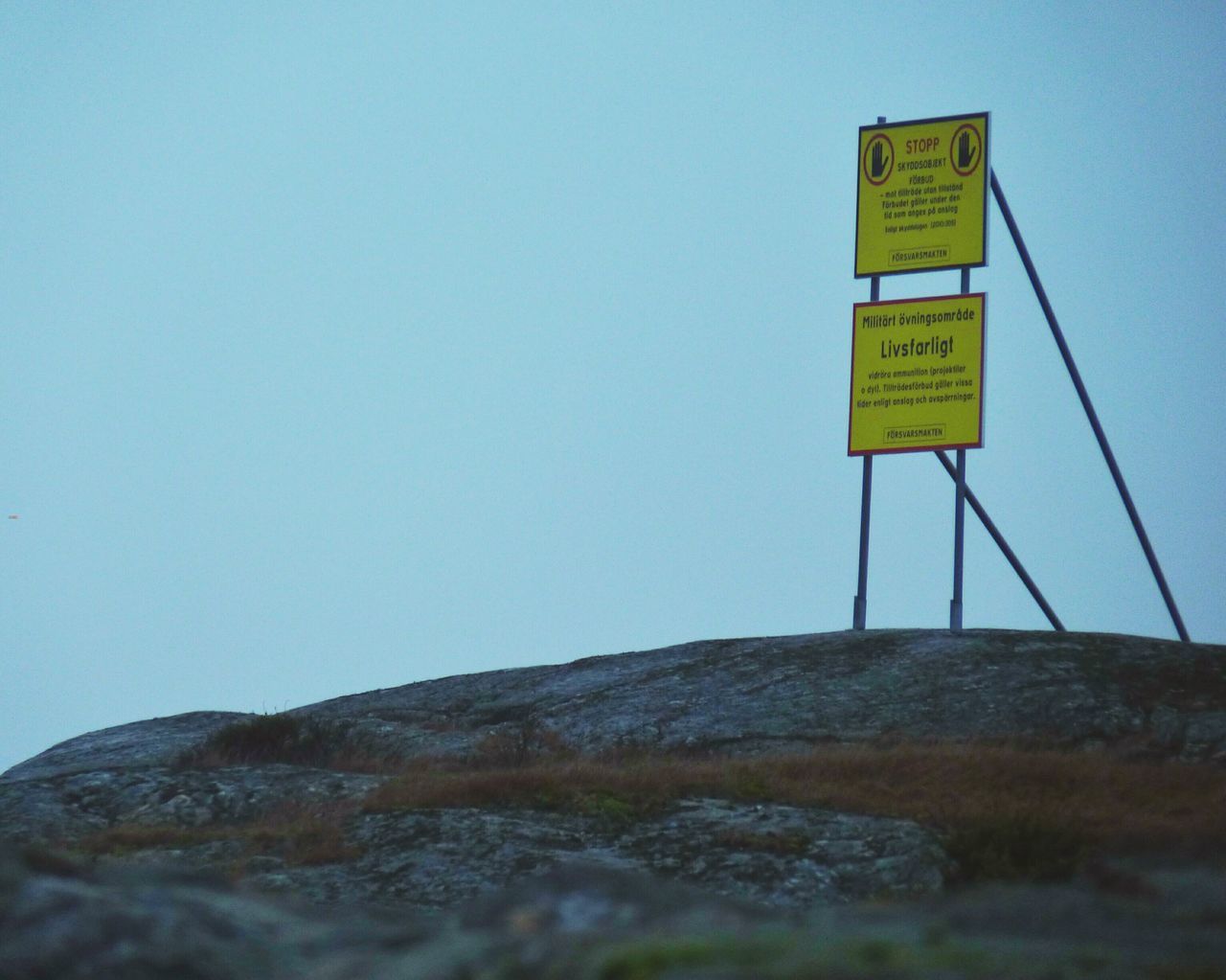 communication, text, western script, guidance, information sign, sign, road sign, clear sky, copy space, information, direction, warning sign, arrow symbol, blue, capital letter, low angle view, directional sign, non-western script, pole, day