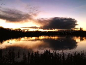 Scenic view of lake against sky during sunset