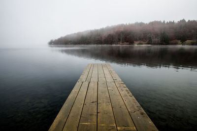 Pier over lake against sky