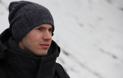 Man in warm clothing looking away outdoors