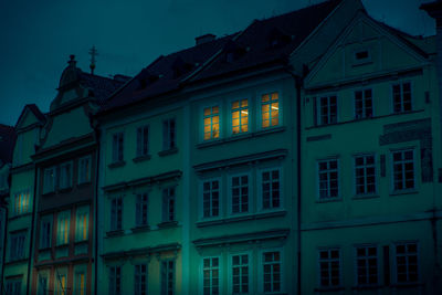 Low angle view of illuminated building against sky at dusk