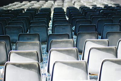 Full frame shot of empty chairs at stadium