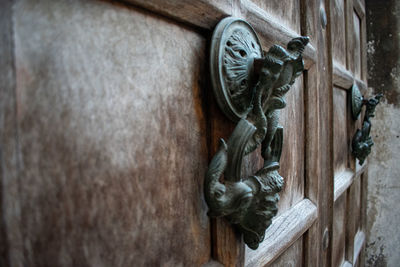 Close-up of old sculpture on wooden door