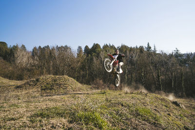 Senior motocross driver riding on circuit