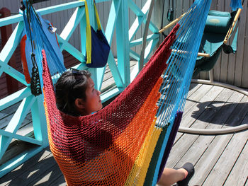 High angle view of girl sitting at hammock