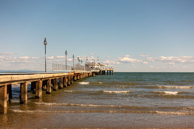 Pier over sea against clear sky