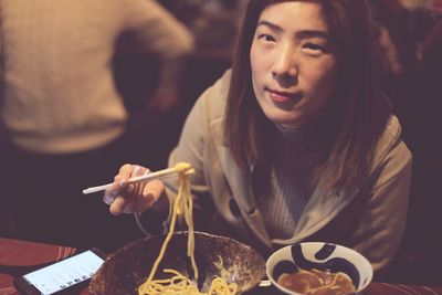 Portrait of woman having food at restaurant