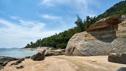 Scenic view of cliff by sea against sky