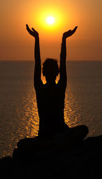 Silhouette of woman doing on beach