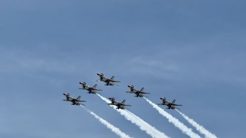 Low angle view of airshow against clear sky