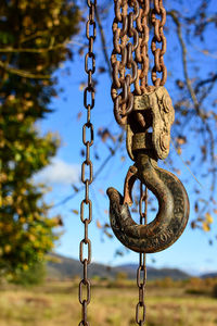 Close-up of metal chain hanging outdoors