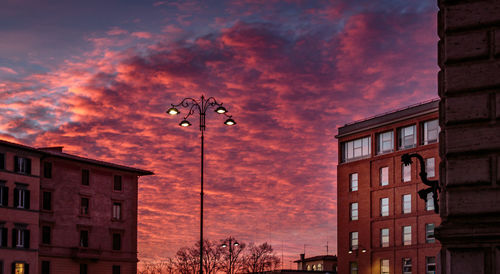 Low angle view of buildings against cloudy sky