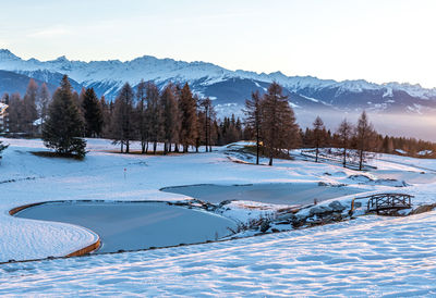 Scenic view of snow covered mountains against sky