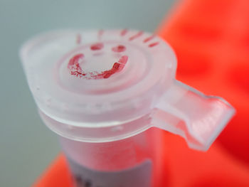 Close-up of smiley face on plastic container in lab