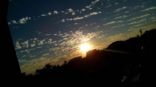 Silhouette trees against sky during sunset