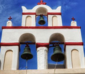 Low angle view of bell tower against blue sky