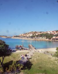 High angle view of people at beach against blue sky in city